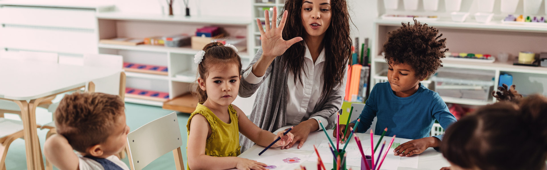 Photo of a young woman teaching pre-schoolers