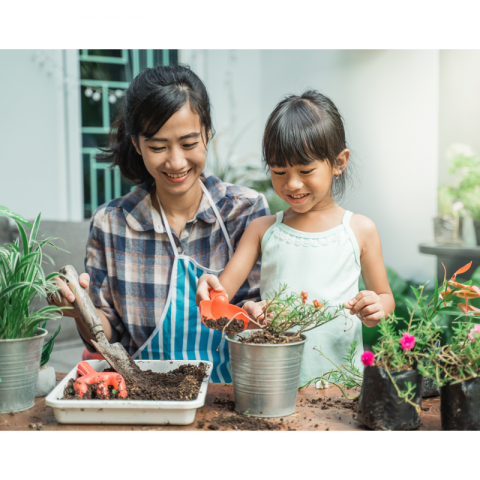 daughter and mother planting a flower